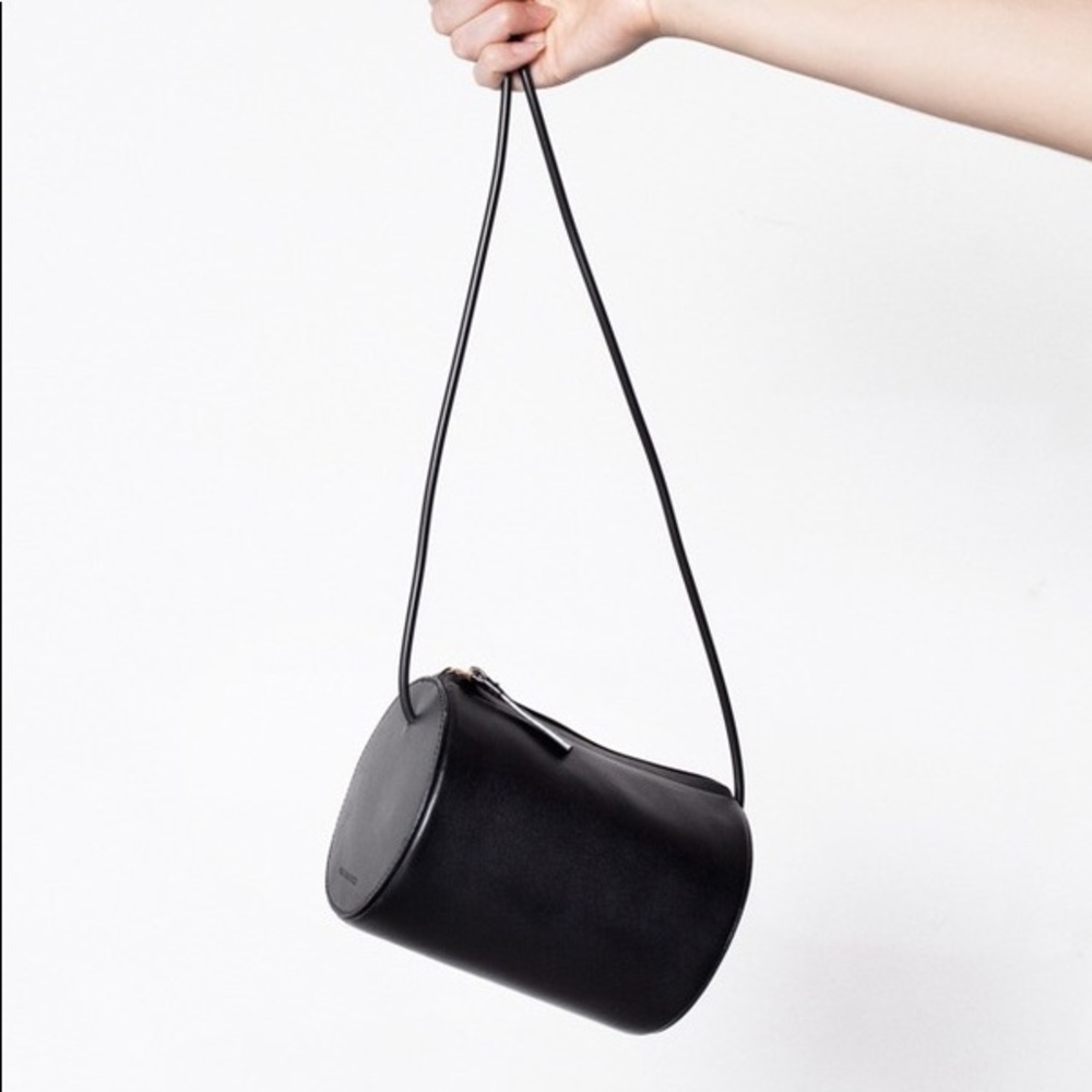 Black crossbody leather cylindrical bag